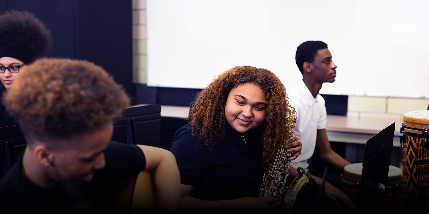 Students playing instruments in a music class.
